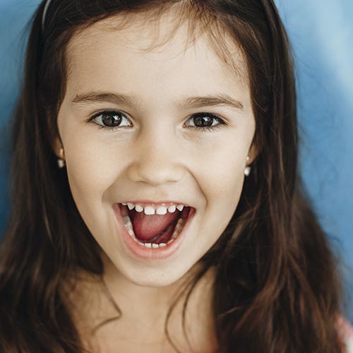 little girl smiling after dental checkup